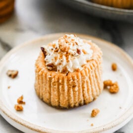 A mini pumpkin cheesecake on a plate