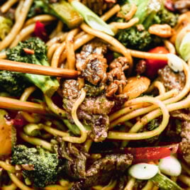 beef and broccoli lo mein with noodles on a plate