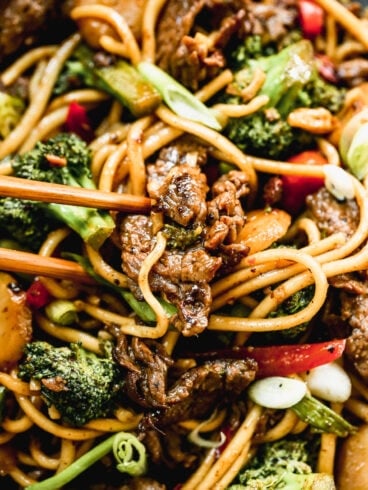 beef and broccoli lo mein with noodles on a plate