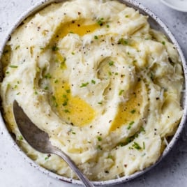 buttery mashed potatoes made in instant pot with herbs, cheese, butter, and greek yogurt