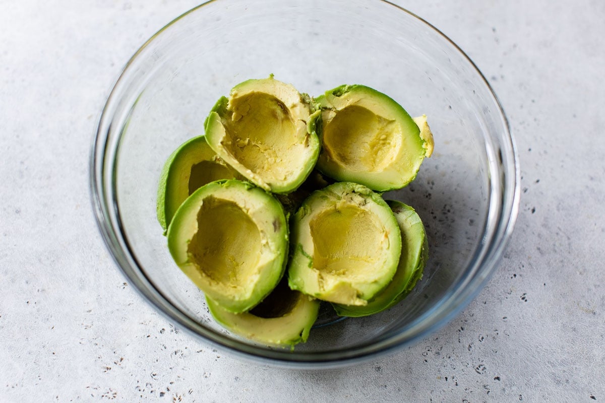 Halved avocados in a bowl