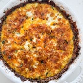 a golden brown quiche in a broccoli pie crust