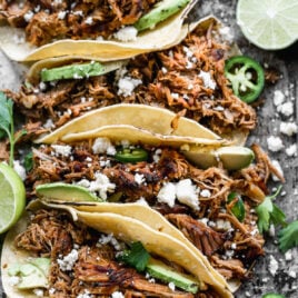 Slow cooker pork carnitas in tortillas