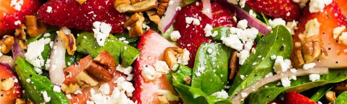 spinach strawberry salad with poppy seed dressing in a bowl