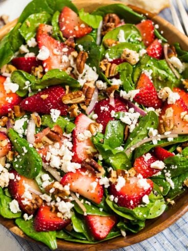 spinach strawberry salad with poppy seed dressing in a bowl