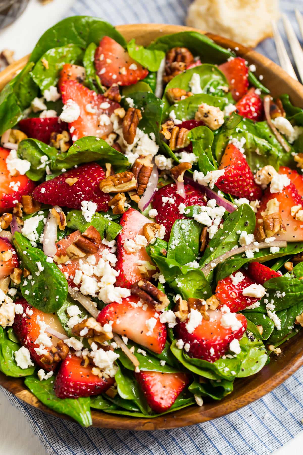 spinach strawberry salad with poppy seed dressing in a bowl